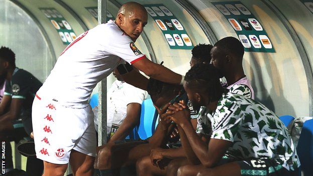 Tunisia's Wahbi Khazri consoled players on the Nigeria bench after full-time