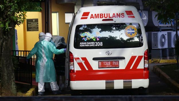 An ambulance arrives with patients at Sulianti Saroso Hospital in Jakarta