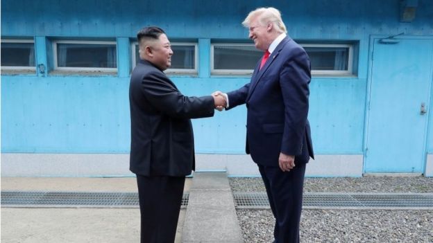 US President Donald Trump shakes hands with North Korean leader Kim Jong Un as they meet at the demilitarized zone separating the two Koreas, in Panmunjom, South Korea, 30 June 2019.