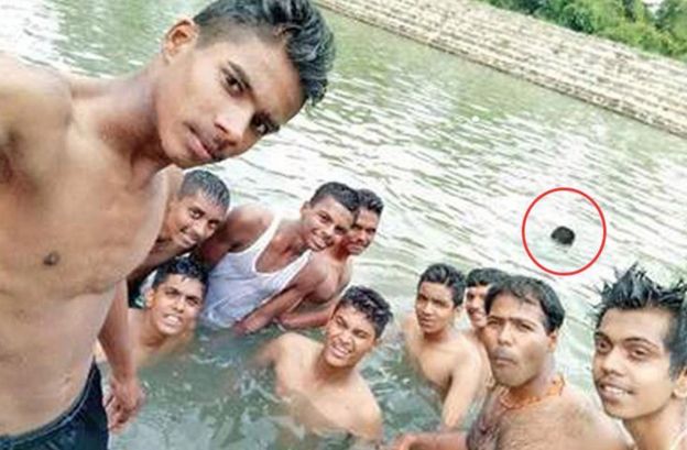 The photo shows a student drowning in the pond during a selfie