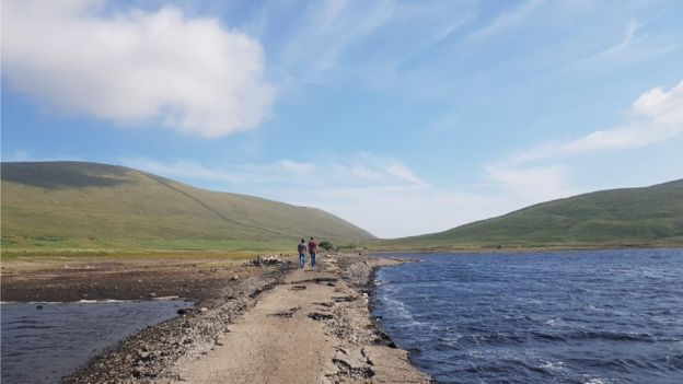 People walking along the old road at Spelga Reservoir