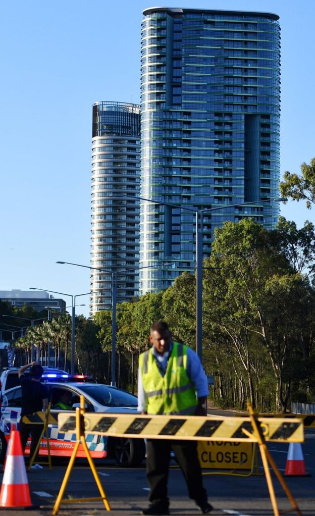 Authorities cordon off a street leading to the Opal Tower (C, back) at Sydney Olympic Park in Sydney, Australia,