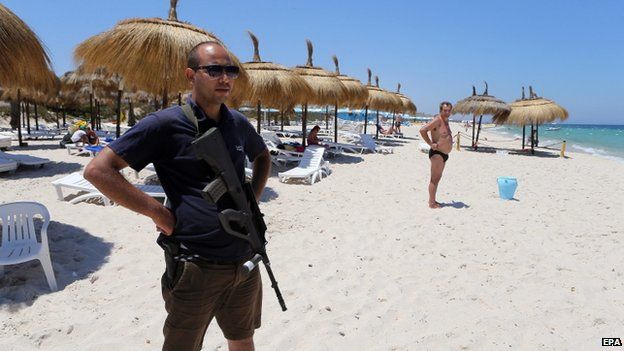 A Tunisian policeman keeps watch on Sousse beach on 1 July