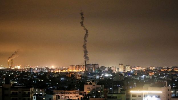A picture shows the smoke trail of a rocket, fired by Palestinian militants, over the Gaza Strip