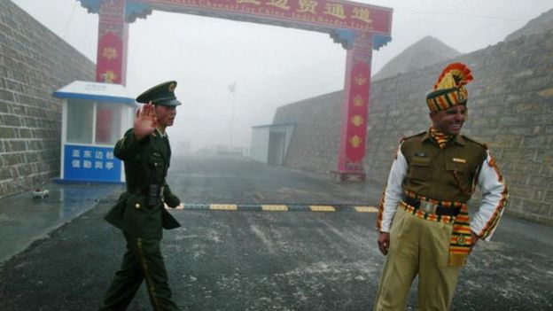 A Chinese soldier and an Indian soldier stand guard at the Chinese side of the ancient Nathu La border crossing between India and China in 2008