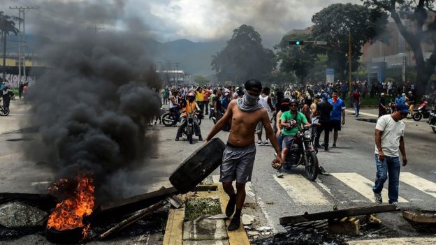 Anti-government activists build a barricade in Valencia