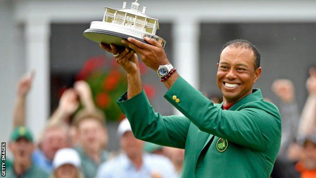 Tiger Woods with Masters trophy and Green Jacket after victory in 2019