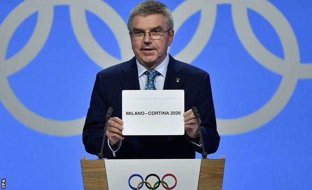 IOC president Thomas Bach opens the envelope announcing Milan-Cortina has won the bid