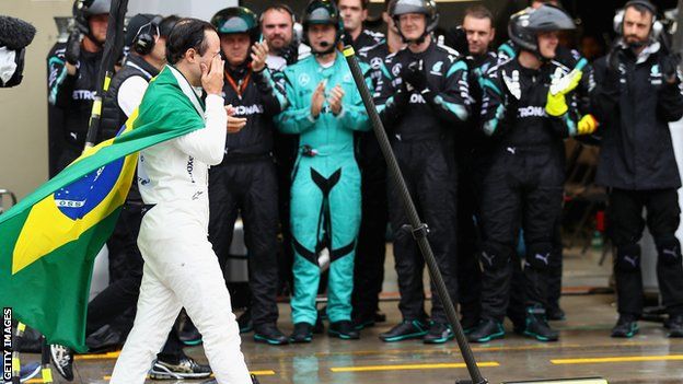 The Mercedes team applaud an emotional Massa as he walks down the pit lane