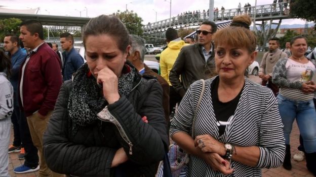 People wait for information about their relatives at the place where a bomb car cause an explosion at the Escuela General Santander de la Policia (Santander General Police School) in Bogota, Colombia, 17 January 2019