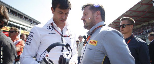 Toto Wolff, Executive Director (Business), Mercedes AMG, and Paul Hembery, Director, Pirelli Motorsport, on the grid.