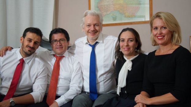 An undated photo issued by Wikileaks shows Julian Assange with his partner Stella Morris (to his left) alongside other members of his legal team