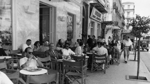 Customers enjoying the sunshine at an open air cafe in Athens, 1947