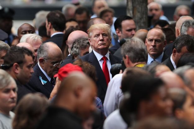 Republican presidential candidate Donald Trump (C) attends a commemoration ceremony for the victims of the September 11 attacks at the National September 11 Memorial and Museum in New York, 11 September