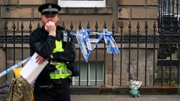 Police and flowers at the scene