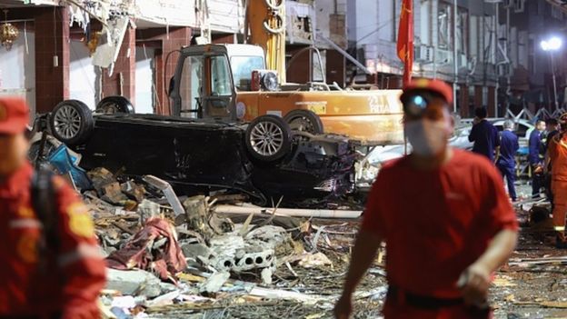 Damaged vehicles and buildings at the site of a tanker explosion near Wenling, in China's eastern Zhejiang province