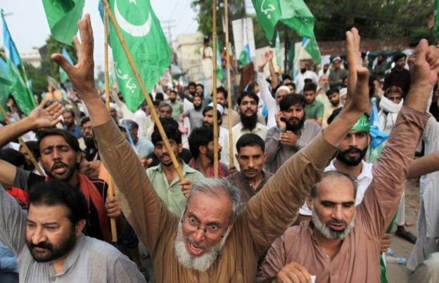 Pakistani men in Lahore chant slogans at a rally expressing solidarity with the people of Kashmir