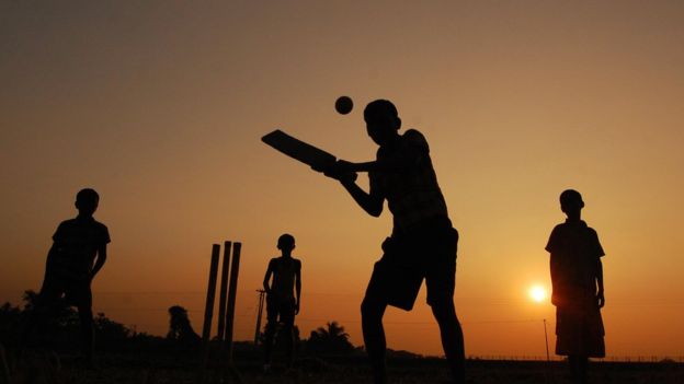 Indian children play cricket