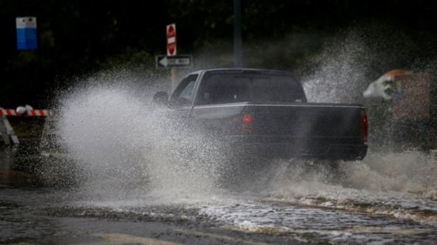 A man drives his vehicle around the Union Point Park Complex through floodwaters as the Hurricane Florence comes ashore in New Bern