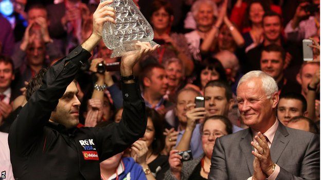 Ronnie O'Sullivan celebrates his 2014 Masters success with Barry Hearn joining in the applause