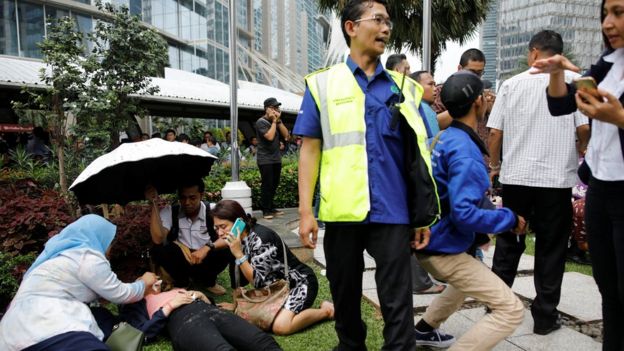 Injured people are treated outside the Indonesian Stock Exchange building
