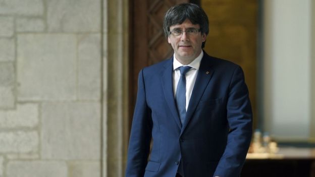 Carles Puigdemont, wearing a suit at Cataln government headquarters