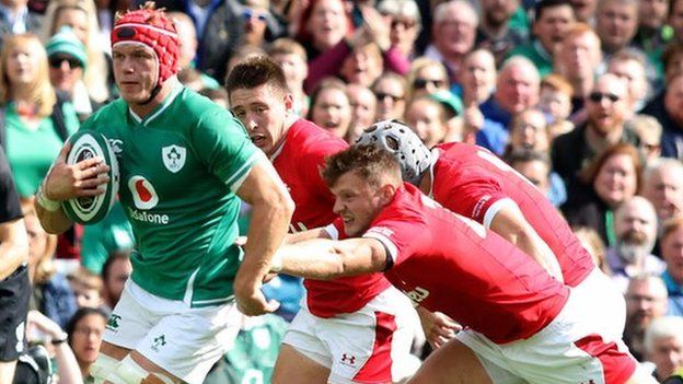 Welsh defenders try to halt the progress of Josh van der Flier in Dublin