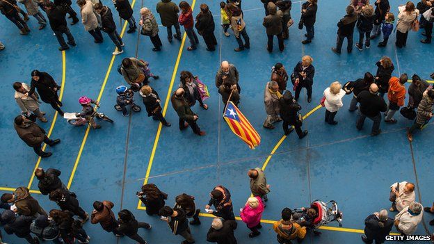 People wait for their turn to cast their vote at a polling station on November 9, 2014 in Barcelona, Spain. Catalans vote today during an unofficial and non-binding consultation on independence of Catalonia from Spain.