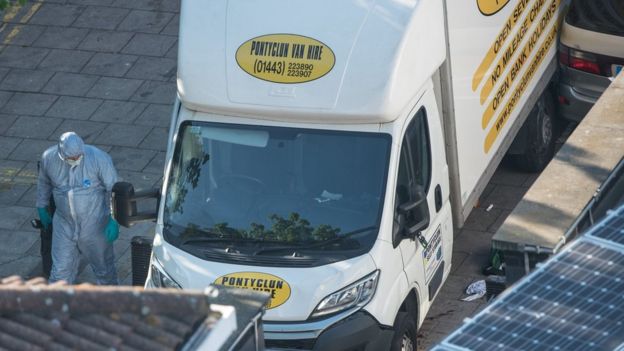 A forensic officer and a white van