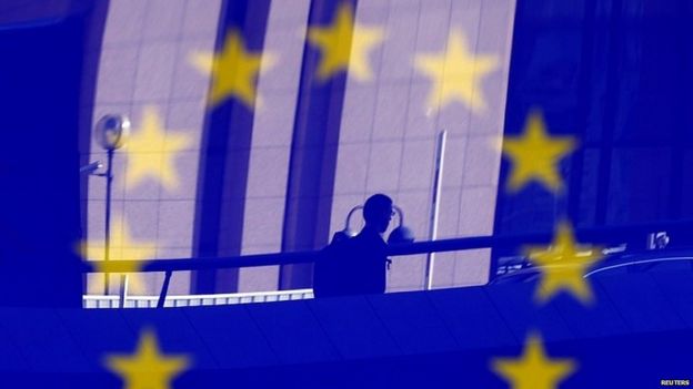 Man against backdrop of EU flag in Brussels