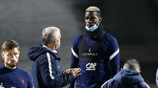 Didier Deschamps talks to Paul Pogba during training for the France national team