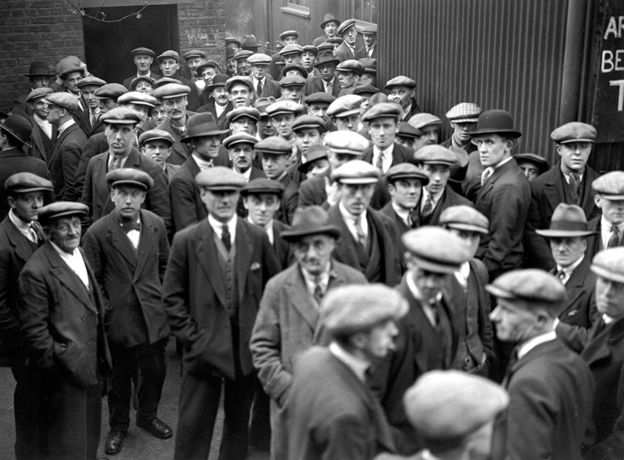 Unemployed men queuing for work