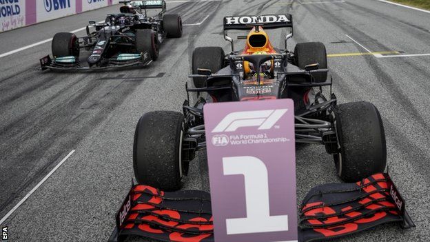 Max Verstappen's Red Bull parked up in front of Lewis Hamilton's Mercedes