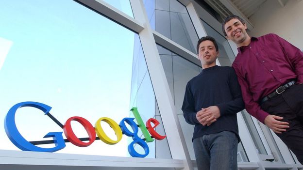 Co-fundadores de Google, Larry Page y Sergey Brin, junto al cartel de la empresa.