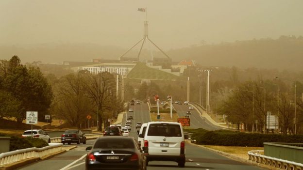 View of road leading to Parliament House shrouded by smoke from the city's fires on Thursday