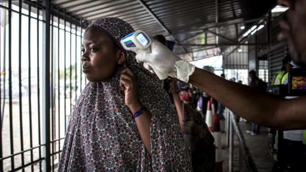 A woman in Democratic Republic of Congo getting screened for Ebola