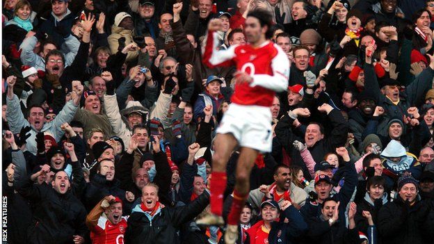 Robert Pires celebrates scoring for Arsenal in front of his team's fans