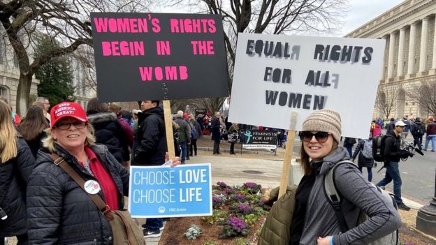 Protesters holding anti-abortion signs