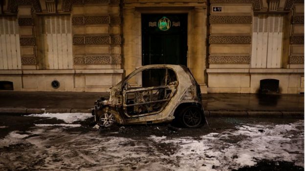 A vandalised, burnt car is seen after clashes at a demonstration by the "yellow vests" movement in Paris, 8 December