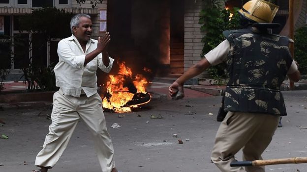 A follower of Indian religious leader Gurmeet Ram Rahim Singh pleads for his safety - 25 August 2017