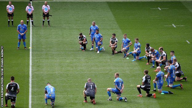 Ospreys and Cardiff Blues players mark rugby against racism before the 20-20 draw at the Liberty Stadium