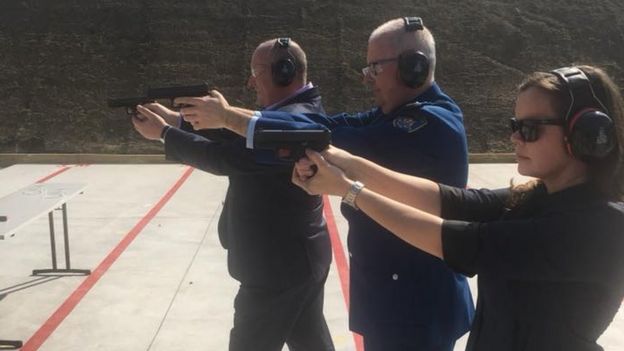 David Elliot and others shoot pistols at targets as part of a rifle range opening in Sydney