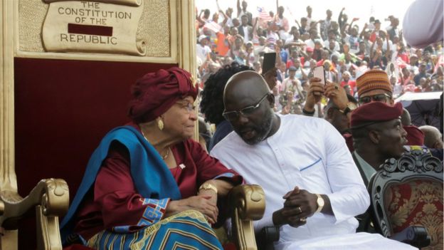 Liberia's former President Ellen Johnson Sirleaf and the new President elect George Weah speak during his swearing-in ceremony at the Samuel Kanyon Doe Sports Complex in Monrovia, Liberia, January 22, 2018