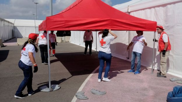 Red Cross volunteers mount a tent at the point of arrival of refugee vessel Aquarius and two other Italian ships expected tomorrow at the port of Valencia, Spain, June 16, 2018