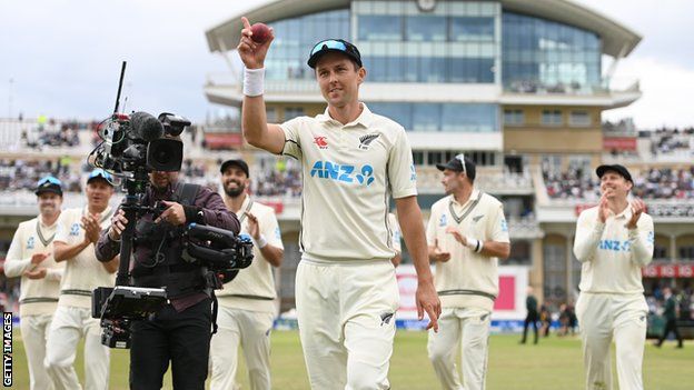 Trent Boult holding up the ball after taking five wickets