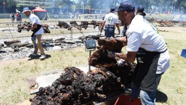 Cooks weigh the beef to reach a total of 16,500 kg, in Rodo Park in Minas, Uruguay, 120 km from Montevideo, in an attempt to break the Guinness record for 