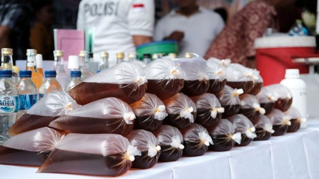 Seized illegal alcohol on display at a police press conference in Jakarta