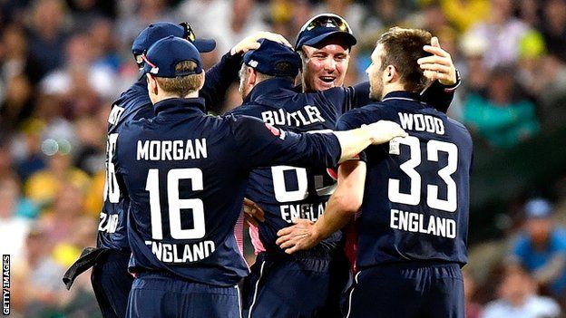 Jos Buttler and his England team-mate celebrate the wicket of Australia captain Steve Smith