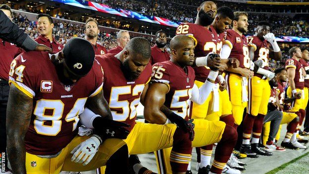 Washington Redskins players take the knee during the US national anthem