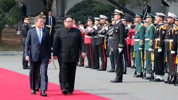 North Korean leader Kim Jong Un (L) and South Korean President Moon Jae-in (R) walk to the official welcome hall after meeting and Kim crossing the military demarcation line (MDL) for the Inter-Korean Summit on April 27, 2018 in Panmunjom, South Korea